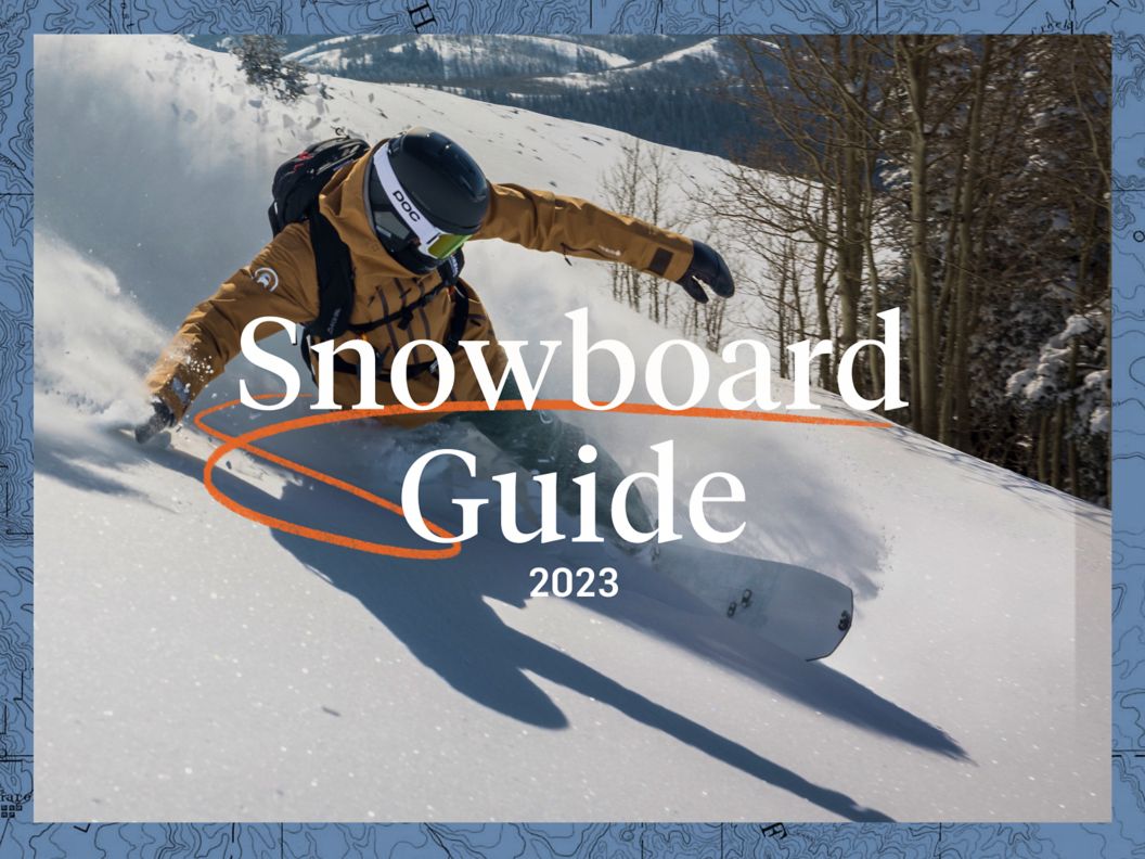 A snowboarder shuffles into a drop-in. 